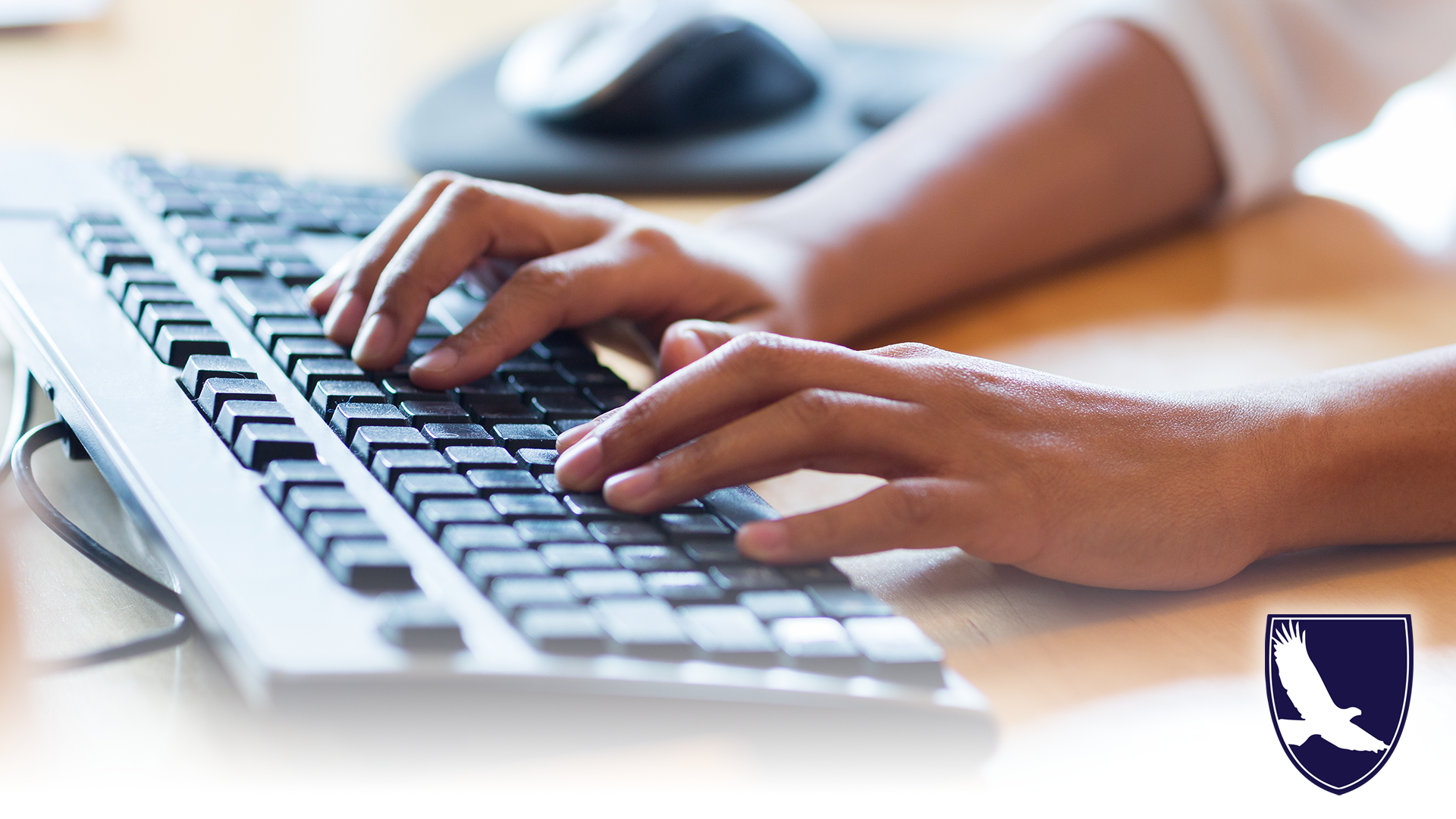 hands typing on black keyboard
